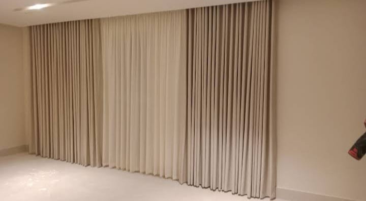 Luxury floor-length drapes with chandelier — premium curtains Riyadh