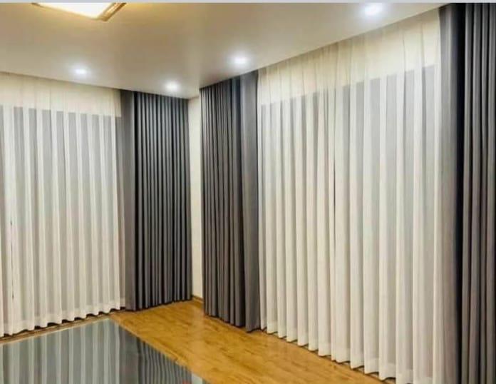 Grey curtains with sheer panel — custom curtains Riyadh in elegant neutral tones