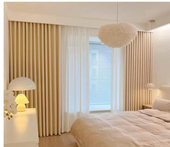 Arch window bespoke curtains in a Riyadh bedroom — elegant curtain installation