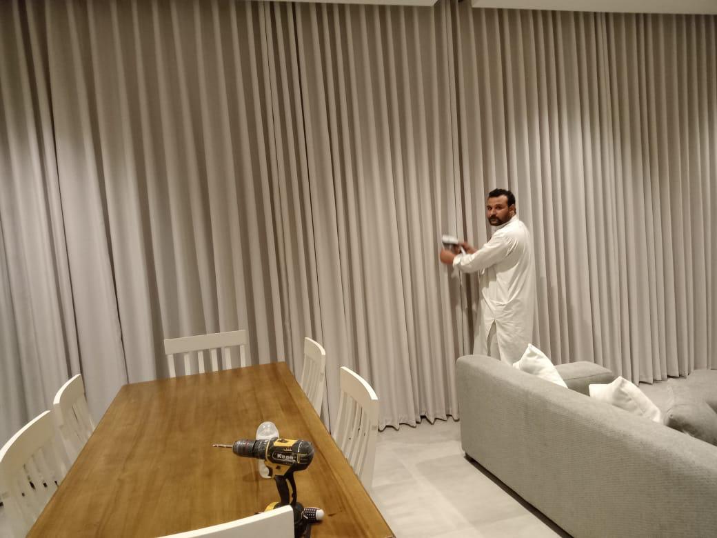 Pinch-pleat dark curtains — custom curtain installation Riyadh for refined interiors